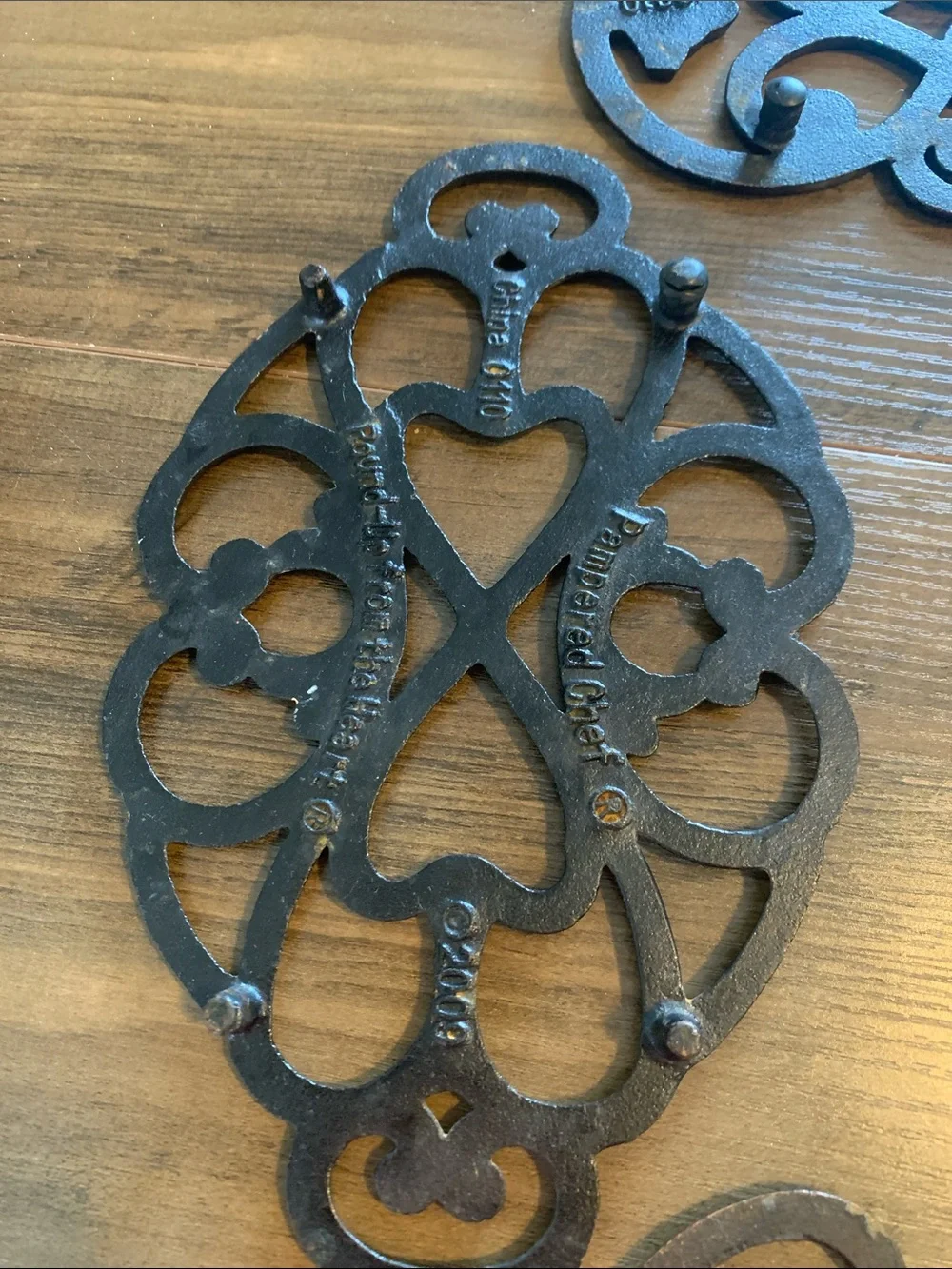 The Pampered Chef Copper-Tone Ornate Trivet Set.